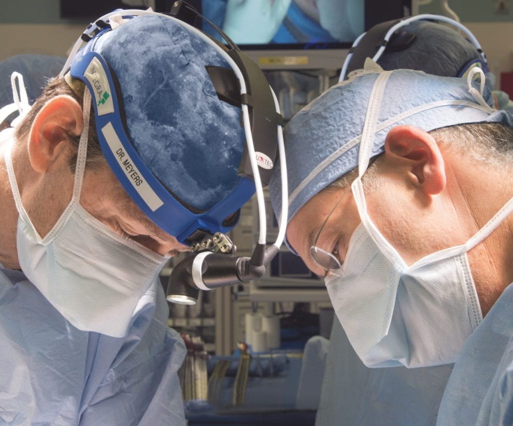 Lung surgeons in operating room wearing surgical scrubs
