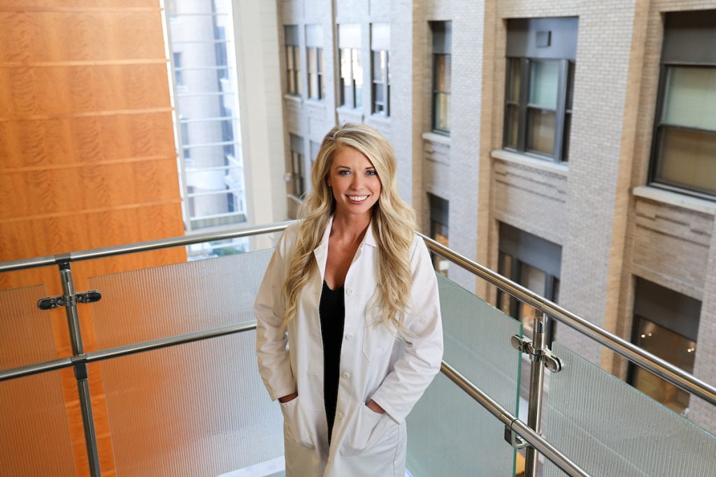 Dr. Shepherd in white lab coat on stairs at Washington University School of Medicine